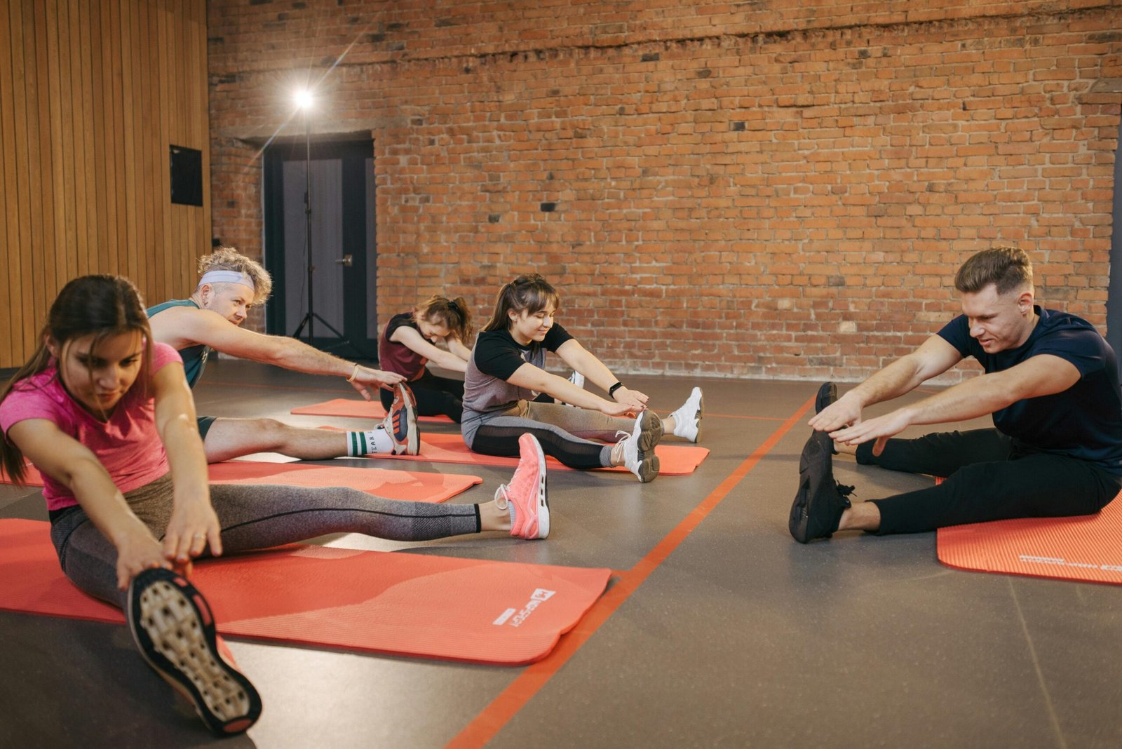 Fitness class members stretching